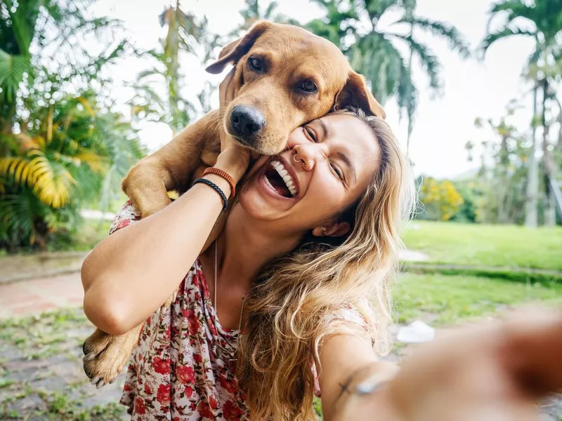 Young Woman Takes Selfie With Her Dog