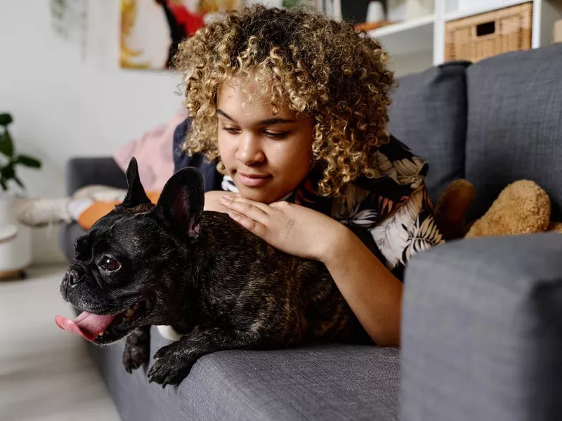 Girl resting at home with her dog