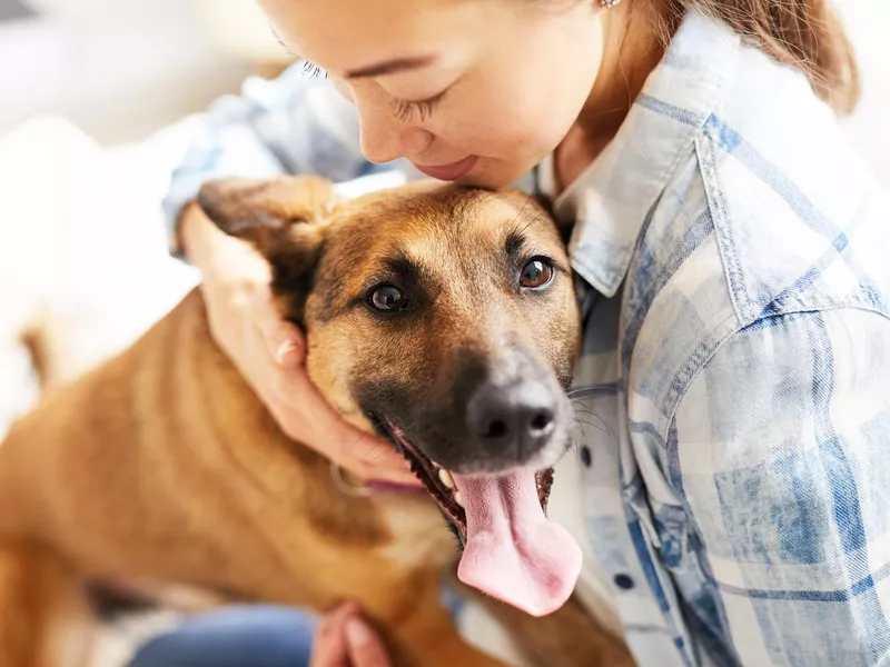 Woman Embracing Dog