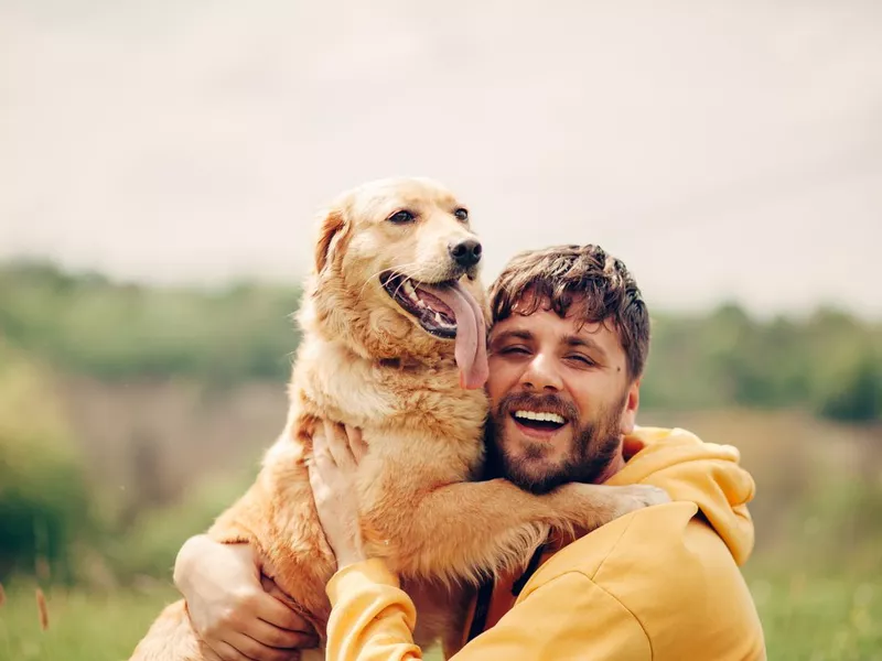 Guy and his dog, golden retriever, nature