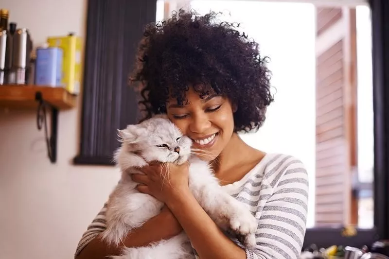 Woman showing how to pet a cat